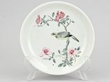 chinese porcelain plate with a bird on a branch and flowers