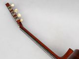a guitar that is sitting on a white surface