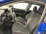 the interior of a blue car with a steering wheel and dashboard