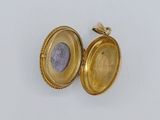 an image of a gold locke with a coin inside of it
