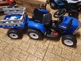 a blue toy tractor with a trailer and a cart