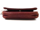 a close up of a brown purse on a white background