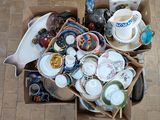 a box full of assorted dishes and cups on the floor