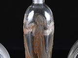 three glass vases sitting next to each other on a black surface