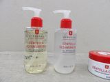 a bottle of cleanser and a container of cleanser sitting on a table