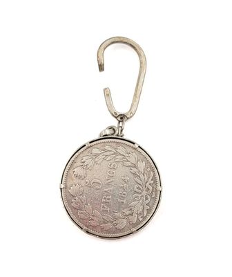 an image of a silver coin with a keychain on a white background