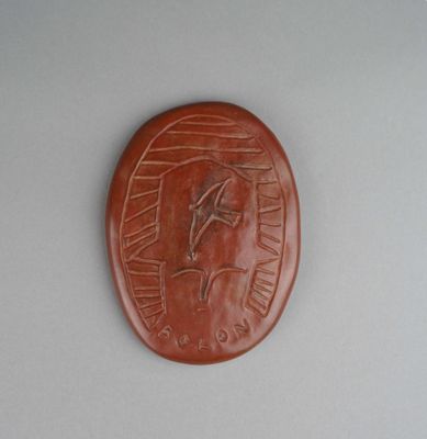 a brown plaque with a picture of a horse on it