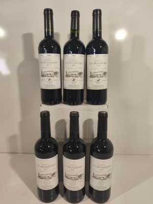 six bottles of wine sit on a shelf in front of a white wall
