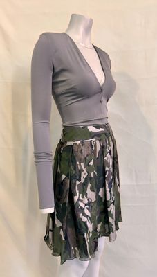 grey and green camo skirt with long sleeves and a v - neck top