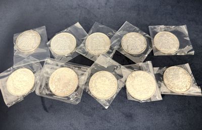 six quarters of gold coins in plastic bags on a black surface