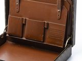 a brown suitcase with a brown handle and a brown leather case