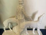 a statue of a woman and a dog on a table