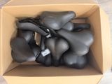 a cardboard box with a bunch of black balloons in it