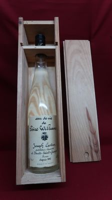 an empty bottle of wine in a wooden box on a red cloth