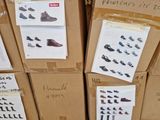 several boxes of shoes are stacked on top of each other