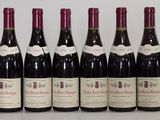six bottles of wine are lined up on a table