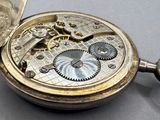 a silver pocket watch with a chain attached to it
