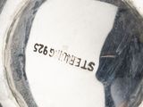 a close up view of a silver vase with a label on it