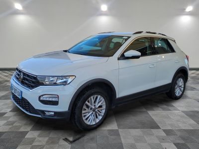 a white volkswagen suv parked in a large room