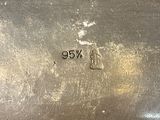 a silver plate with a number on it sitting on a table