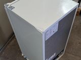 a white refrigerator sitting in the corner of a room