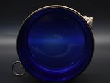 a close up of a blue glass bowl on a black surface