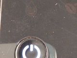 a close up of a cell phone with a button on it