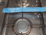 a blue tape on the burner of a gas stove
