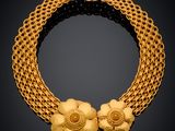 a gold necklace with flowers on a chain