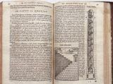 an open book with a drawing of a tower on it
