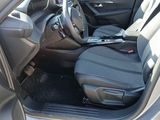 the interior of a car with the door open showing the driver ' s seat