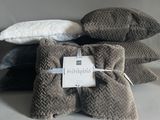 several pillows are stacked on top of each other on a table