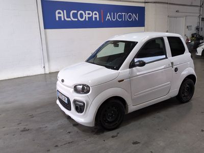 a small white car that is parked in a garage