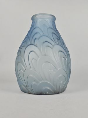 a glass vase with a blue and white design on it