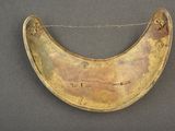an old brass plate with a chain hanging from it ' s side