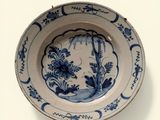 a blue and white plate with a design on it