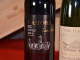 two bottles of wine sitting next to each other on a table