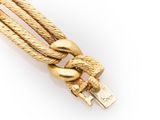 a close up of a gold colored cable with a knot on it