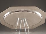 a silver plate with a metal stand on it