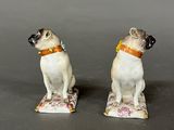 pair of porcelain figurines of a dog and a cat