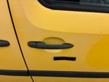 a close up of a yellow car with a black door handle