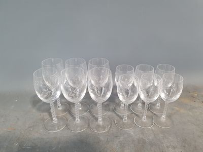 six empty wine glasses lined up on a concrete surface