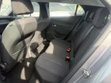 the back seats of a car with a bottle of beer in the passenger seat