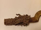 brass plated pipe holder with a bird on it and a snake on the handle