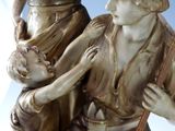 a statue of a man and a woman holding a child