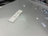 a ruler sitting on the hood of a car