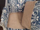 a blue and white chair with a brown pillow on it