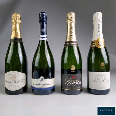 four bottles of champagne are lined up in a row
