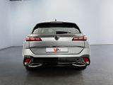 the rear end of a silver car in a white room