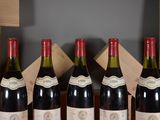 four bottles of wine are lined up on a table